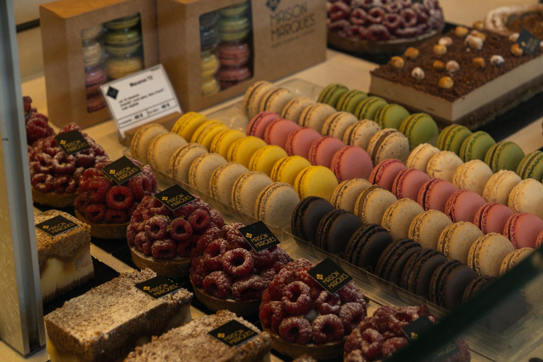 Indulge in a colorful array of macarons and pastries at a Parisian patisserie, showcasing French culinary artistry.