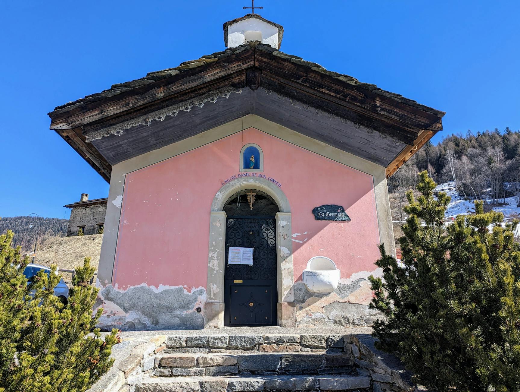 Charming small chapel in Sainte-Foy-Tarentaise, Auvergne-Rhône-Alpes, France, under a clear blue sky.